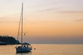 Yacht at sunset. A yacht in the sea bay against the backdrop of a beautiful sunset. Travel and romance concept Royalty Free Stock Photo