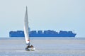 Yacht under Sail with large container ship Royalty Free Stock Photo