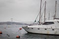 Yacht waiting moored at the port and the bridge in the background.