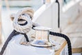 Nautical background, ropes tied on cleat of boat deck at marina Royalty Free Stock Photo