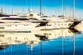 Yachting, luxury yachts boats reflect in blue sea water at marina Royalty Free Stock Photo