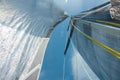 Yachting, sailing, competition, cruise, regatta, freedom, adventure concept. Close up of yacht mast and silver sail with yellow sl