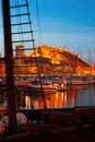Yachts against Castle in night. Alicante
