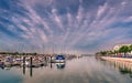 Yachts and boats in Ayamonte marina on a day with an impressive cloudscape reflecting in the water.