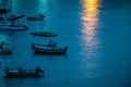 Yachts and boats in the bay. Reflection of light from a lantern on the water. Royalty Free Stock Photo