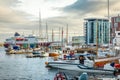 Yachts and boats and cruise liner with modern buildings at the background at pier in port of Svolvaer, Lototen islands, Austvagoya