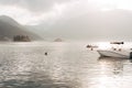 Yachts and boats are moored overlooking the small islands in the Bay of Kotor Royalty Free Stock Photo