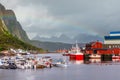 Yachts and boats with mountain in the background and rainbow arc at pier in Svolvaer, Lototen islands, Austvagoya, Vagan