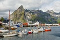 Yachts and boats with mountains in the background at pier in Reine, Moskenesoya, Lototen islands,, Nordland County, Norway Royalty Free Stock Photo