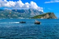 Yachts, boats and parachute in the bay of the city of Budva, Montenegro, the Balkans, the Adriatic Sea. Mountains and clouds. Royalty Free Stock Photo