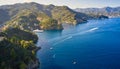 Yachts and boats are sailing in the Ligurian Sea on the mountain background, Portofino, Italy. Rocks and hills seaside with the