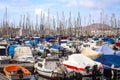 Yachts and boats during a sunny day and palm trees in Las Palmas, Spain