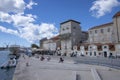 Yachts dock at the pier and tourists visit the promenade of the ancient Venetian city near the Adriatic Sea, Trogir, Croatia Royalty Free Stock Photo