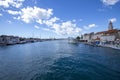 Yachts dock at the pier and tourists visit the promenade of the ancient Venetian city near the Adriatic Sea, Trogir, Croatia Royalty Free Stock Photo