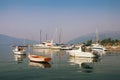 Yachts and fishing boats on the water on a foggy morning. Bay of Kotor, Tivat, Montenegro