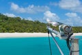 Yachts mast with seagulls and beautiful tropical beach on background