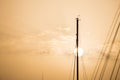 Yachts masts tops under Larnaca` s sky at sunset, sunrise with a circle sun. Pink sky background, copyspace.