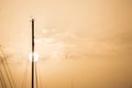 Yachts masts tops under Larnaca` s sky at sunset, sunrise with a circle sun. Pink sky background, copyspace.