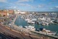 Yachts moored in the marina of the impressive historic Royal Harbour on a bright autumnal day