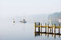 Yachts moored on a misty lake