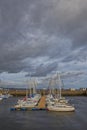 Yachts moored next to a floating Pontoon inside the Marina within the old Harbour of Tayport .