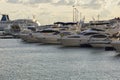 The snow-white yachts moored in the seaport are lined up in a row of different models and types. Russia city of Sochi