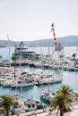 Yachts moored in a row at the pier with a harbor crane Royalty Free Stock Photo