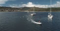 Yachts and motor boat at sea bay of green island coast aerial. Summer passenger cruise on sailboats