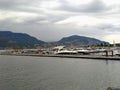 Yachts and motor boats moored at the berth on the Okanagan lake. Mountains Royalty Free Stock Photo