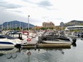 Yachts and motor boats moored at the berth on the Okanagan lake. Mountains Royalty Free Stock Photo