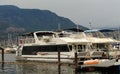 Yachts and motor boats moored at the berth on the Okanagan lake. Mountains Royalty Free Stock Photo