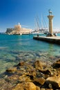 Yachts and old lighthouse in the harbor of Rhodes Royalty Free Stock Photo