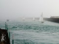 Yachts racing through sea mist
