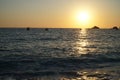 Yachts sail on the sea near a sunny path at sunset. View from the Kabak beach in Turkey. Royalty Free Stock Photo