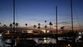 Yachts sailboats in marina harbour. Sail boat masts in twilight. Dusk in harbor, California USA.