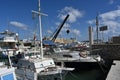 Yachts, sailing boats and old wooden boats with white hulls in Greek port of Heraklion.