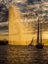 Yachts sailing into the harbour of Geneva, Switzerland at sunset. Royalty Free Stock Photo