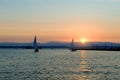 Yachts sailing at sunset