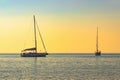 Two yachts on the background of a calm tropical sea horizon.