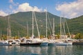 Yachts on water against background of mountains. View of yacht marina of Porto Montenegro. Montenegro, Bay of Kotor, Tivat city Royalty Free Stock Photo