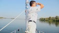 Yachtsman standing on bow of sailing yacht. Sport, recreation