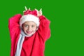 7 yaers old smiling girl with changing tees smiling in santa hat, red pullover, gray scarf, imitation of christmas dear with smile Royalty Free Stock Photo