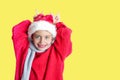 7 yaers old smiling girl with changing tees smiling in santa hat, red pullover, gray scarf, imitation of christmas dear with smile Royalty Free Stock Photo