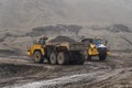 The Komatsu HM400 articulated dump truck operates in an open pit.