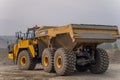 The Komatsu HM400 articulated dump truck operates in an open pit.