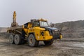 A Komatsu PC1250 excavator loads ore into a Komatsu HM400 dump truck