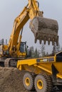 A Komatsu PC1250 excavator loads ore into a Komatsu HM400 dump truck