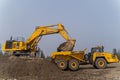 A Komatsu PC1250 excavator loads ore into a Komatsu HM400 dump truck