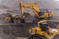 A Komatsu PC1250 excavator loads ore into a Komatsu HM400 dump truck.