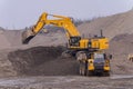 A Komatsu PC1250 excavator loads ore into a Komatsu HM400 dump truck